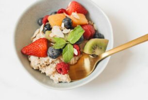 Oatmeal with Sliced Fresh Fruits in a Ceramic Bowl